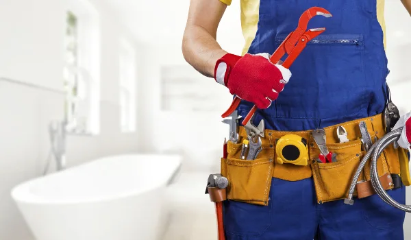 the torso of a plumbing technician showing a tool belt the torso of a plumbing technician showing a tool belt